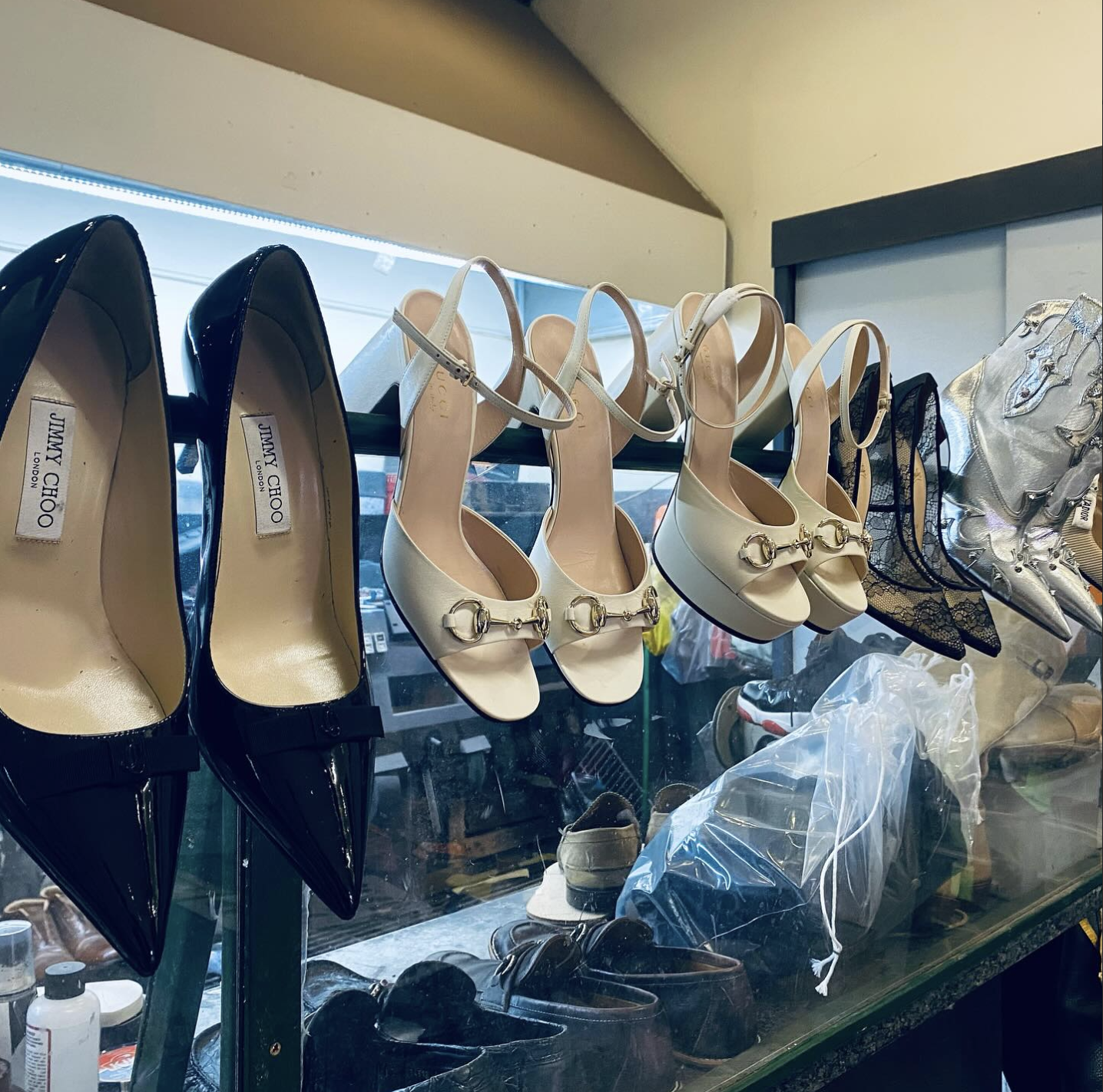 Designer heel mid-repair at Heel Quik's Lenox Square bench